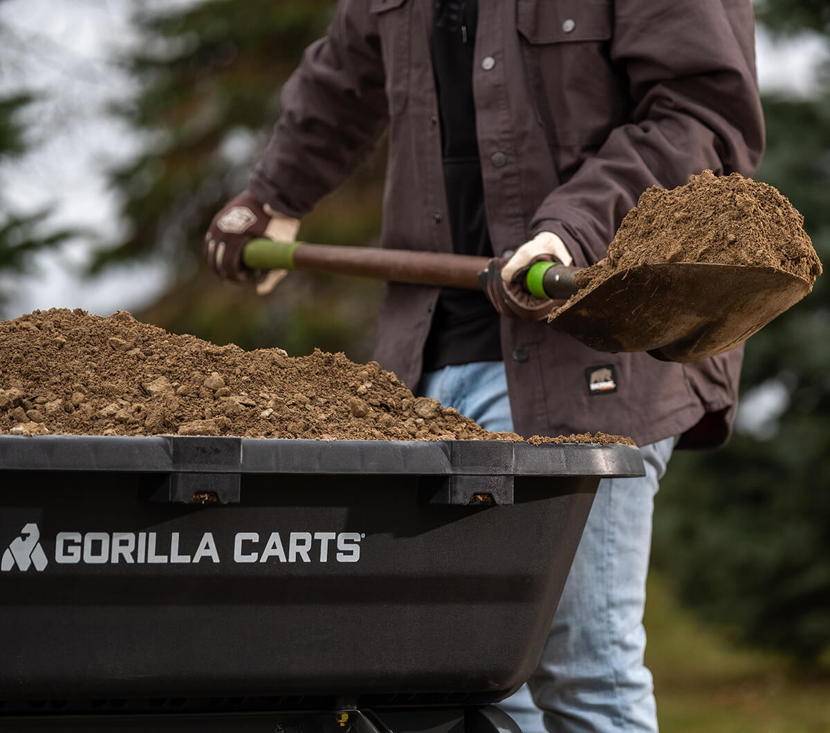 Close up of a man shoveling dirt in 7GCG-NF