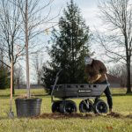 man grabbing dirt from a GOR-10H for a tree