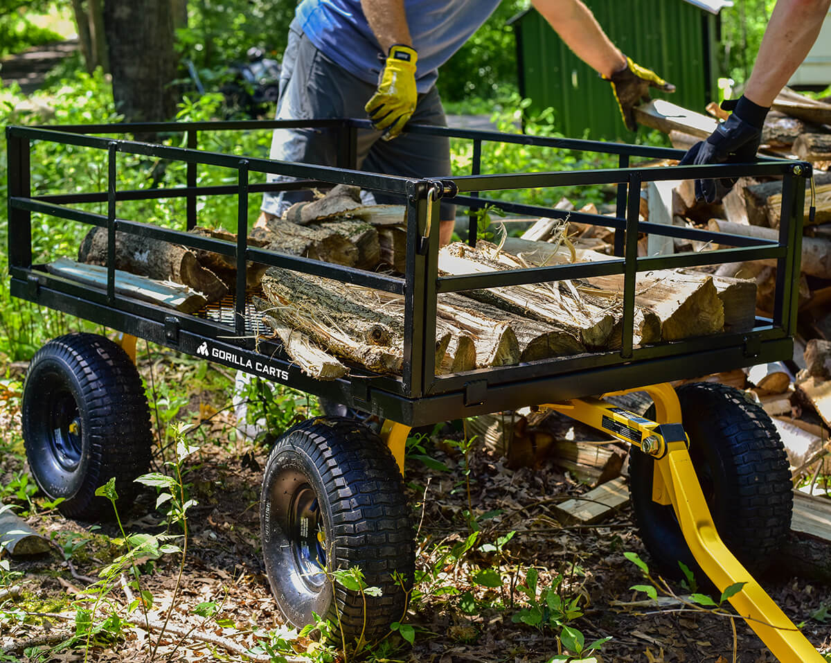 two men placing wood in a GOR1400-COM (-C)