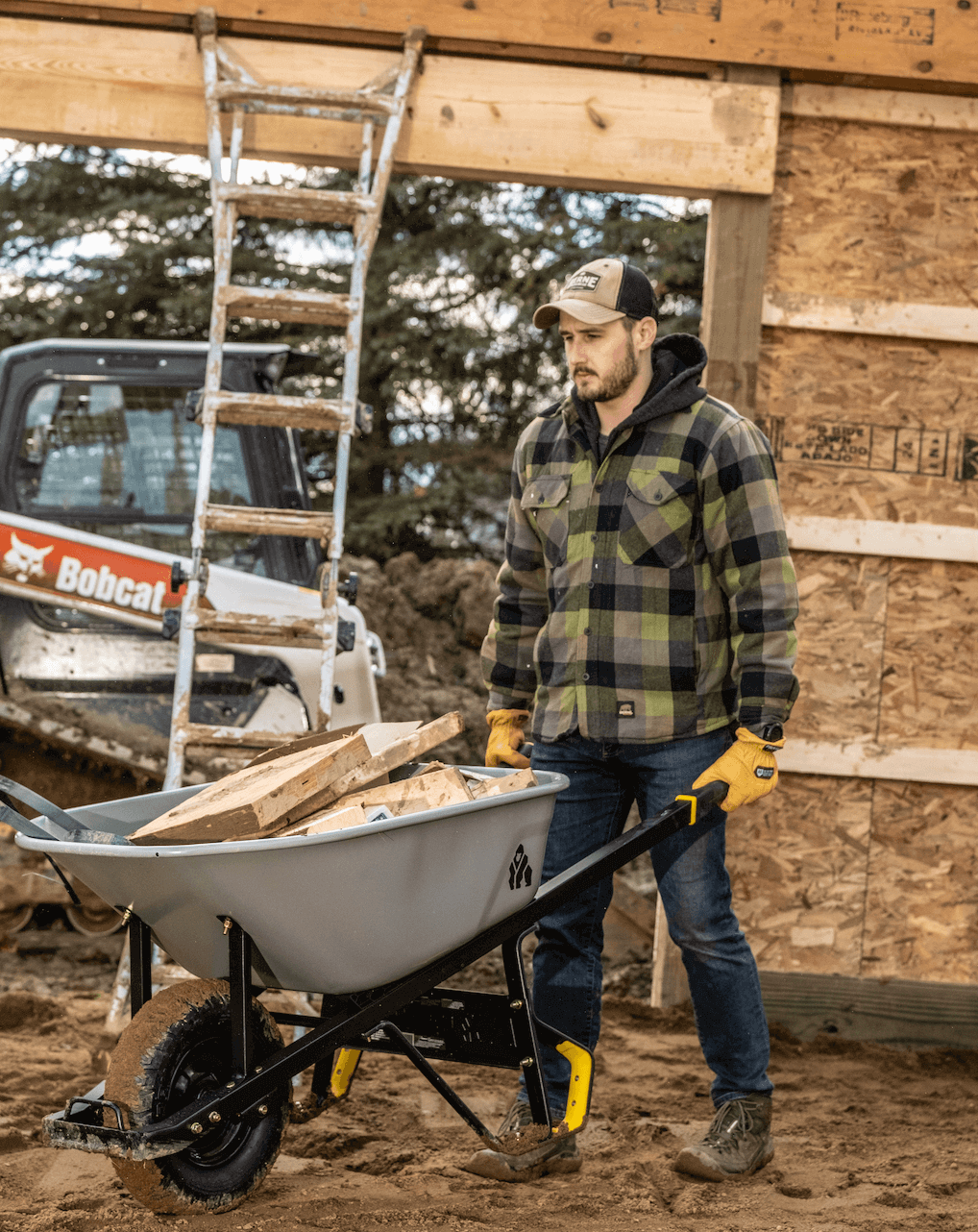 Man pushing GSXD-6 wheelbarrow full of wood